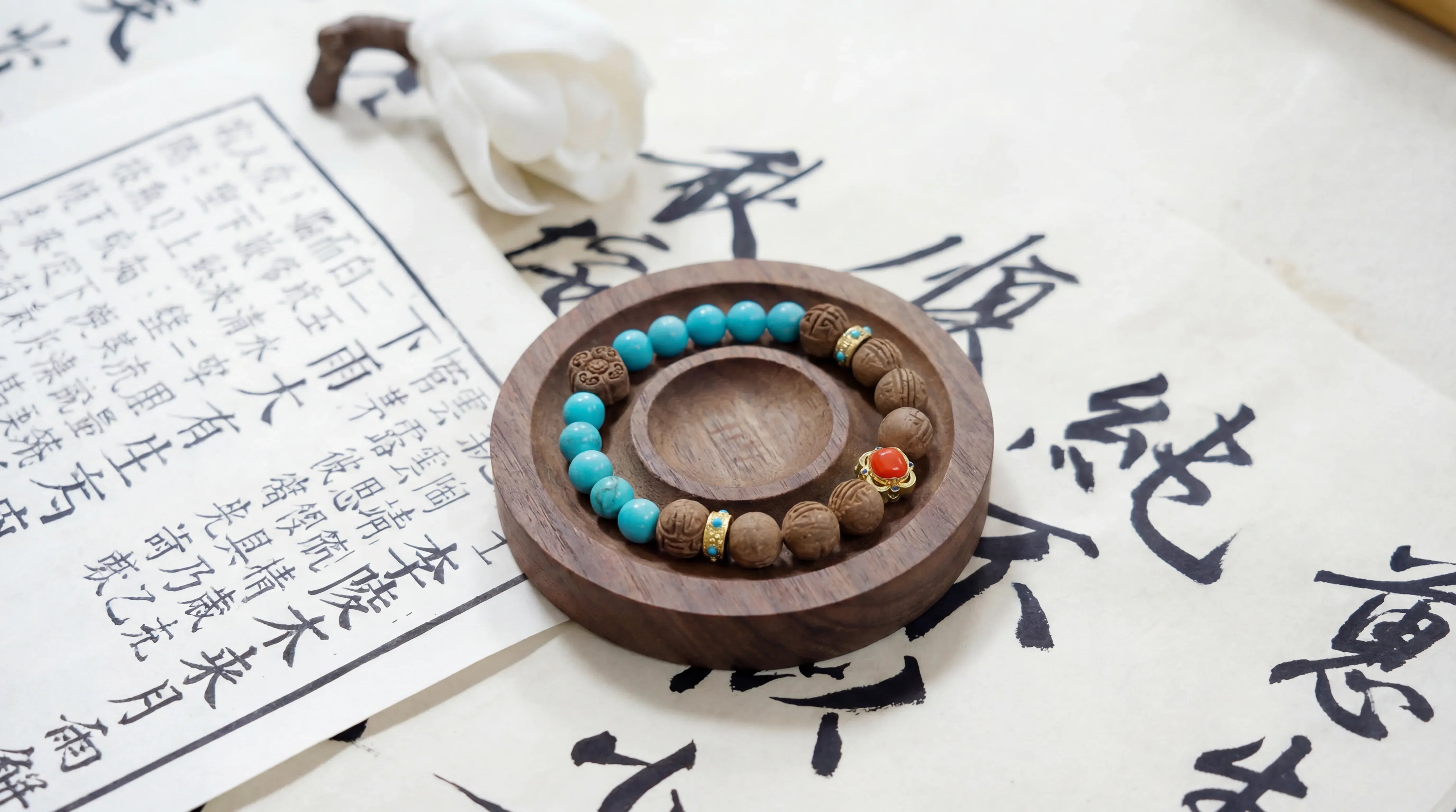 OresGreen Grounded Bracelet: Handcrafted green sandalwood and blue turquoise beaded stone bracelet placed on a walnut wooden tray over Chinese calligraphy paper, displaying elegant minimalist zen jewelry.
