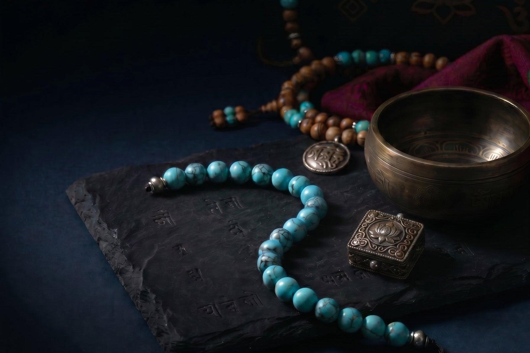 OresGreen flagship collection: A handcrafted natural blue turquoise bead bracelet on a Tibetan inscribed black stone slab, surrounded by a brass singing bowl and meditation mala beads for ultimate spiritual stillness.