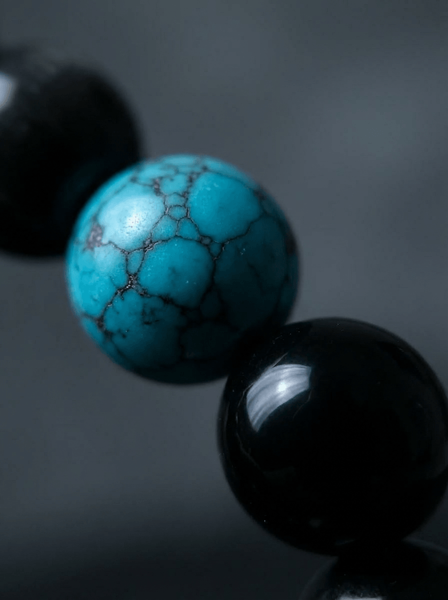 OresGreen Focus Bracelet close-up: High-magnification macro shot showcasing the genuine spiderweb matrix on a natural blue turquoise bead paired with glossy, light-reflecting black obsidian stones.