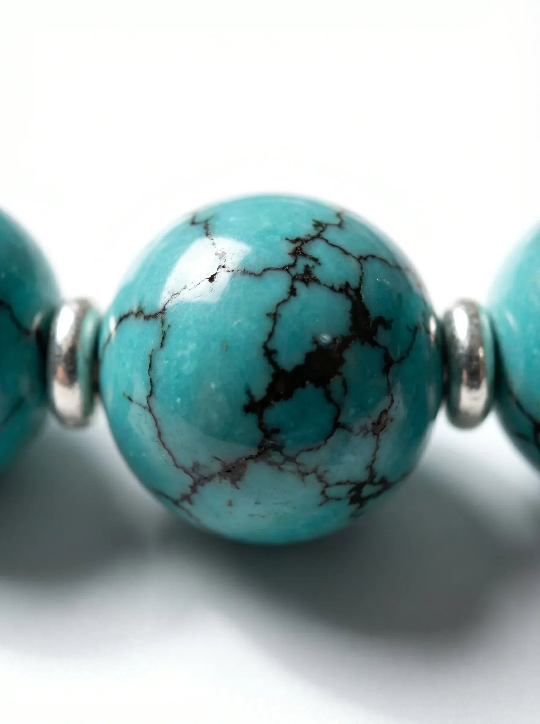 Close-up of natural turquoise beads on OresGreen Stillness Bracelet, showing deep color, natural luster, and smooth polished finish. Its timeless design ensures it stays a staple in your jewelry collection for years.