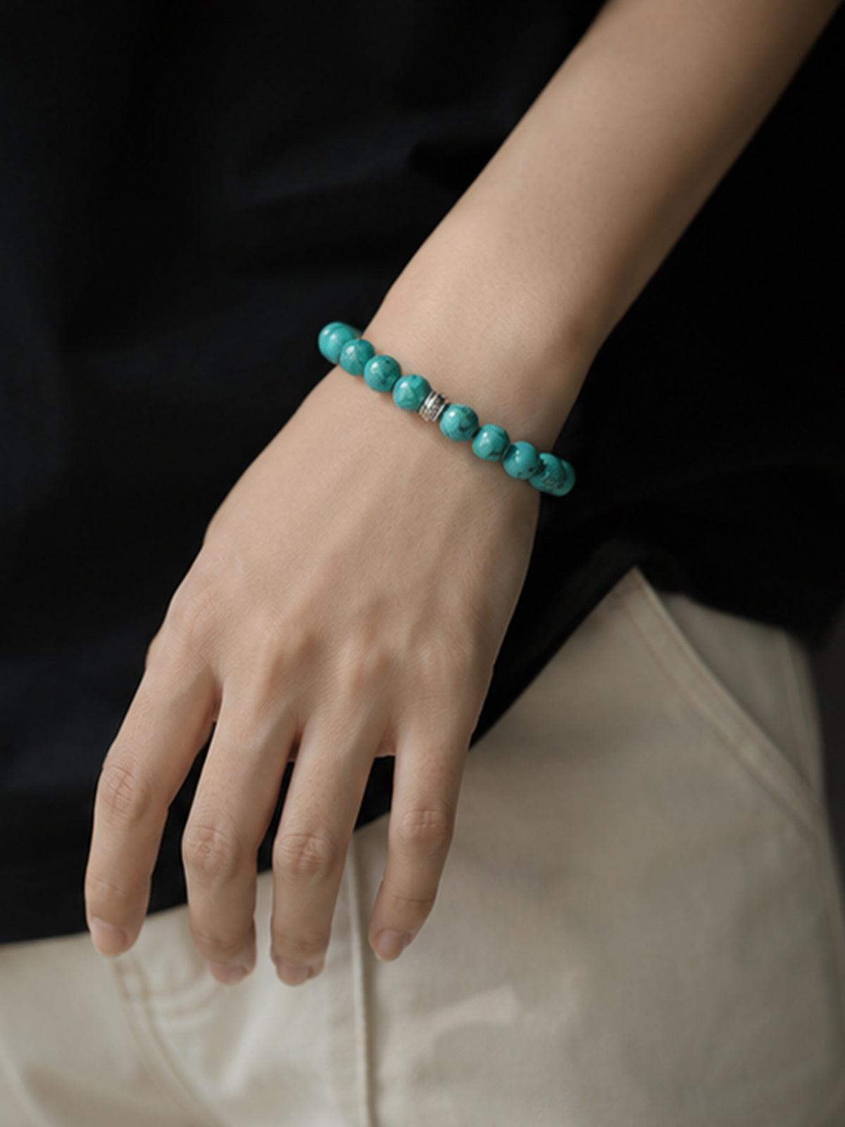 Handcrafted high-porcelain real turquoise gemstone bead stretch bracelet by OresGreen, showcasing a close-up lifestyle wear shot for daily mindfulness and elegant summer fashion.