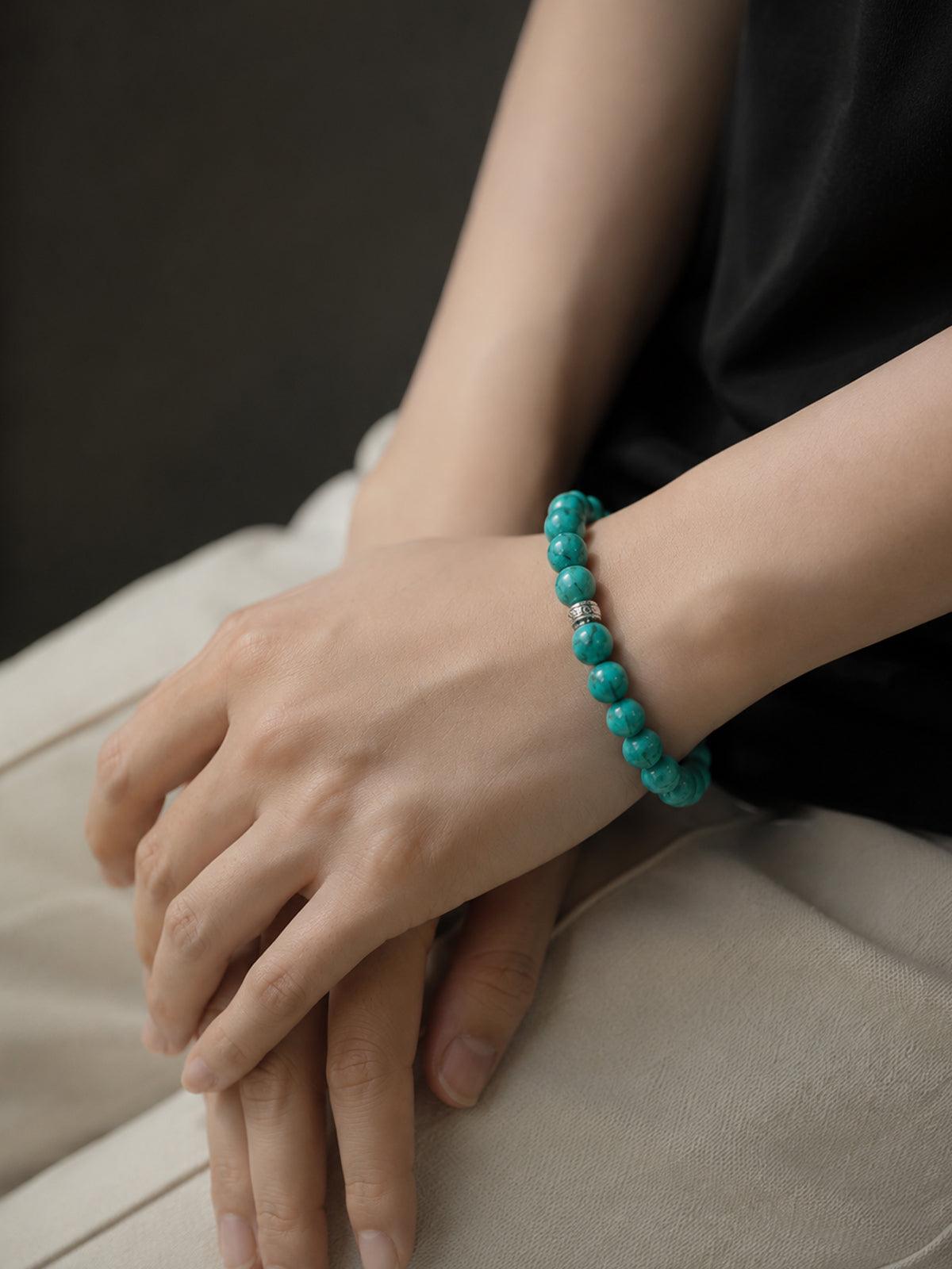 Handcrafted high-porcelain real turquoise gemstone bead stretch bracelet by OresGreen, showcasing a close-up lifestyle wear shot for daily mindfulness and elegant summer fashion.